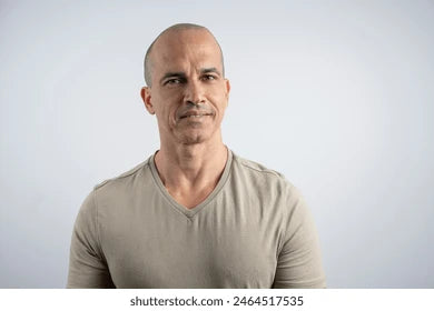 Man wearing a beige shirt against a white background